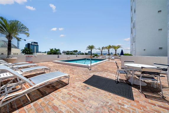 Rooftop area with a swimming pool and lounge chairs.