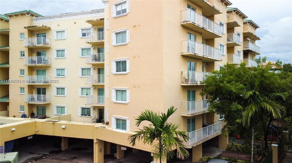 Front view of a multi-story apartment building with balconies.