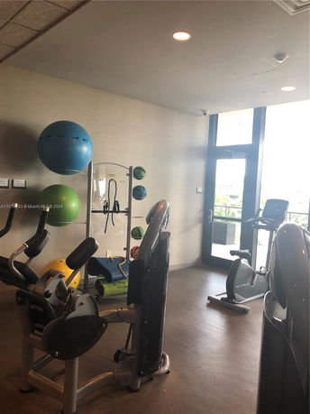 Interior view of a gym area with exercise equipment and fitness balls.