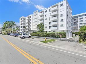 Front view of a multi-story apartment building with balconies.