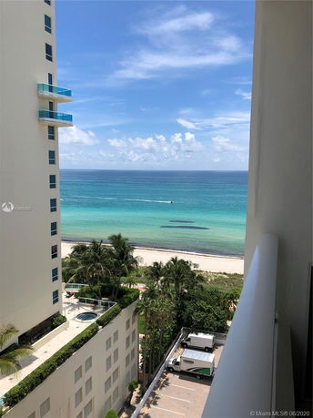 Panoramic view of the beach and ocean from a high-rise building.
