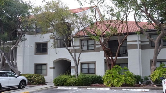 Front view of a two-story building with a red-tiled roof.