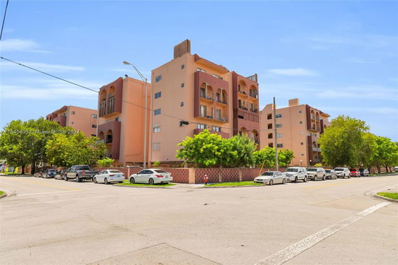 Front view of a multi-story apartment building with balconies.