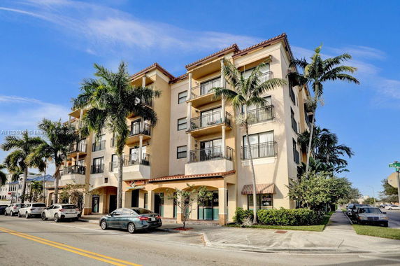 Front view of a multi-story apartment building with balconies.