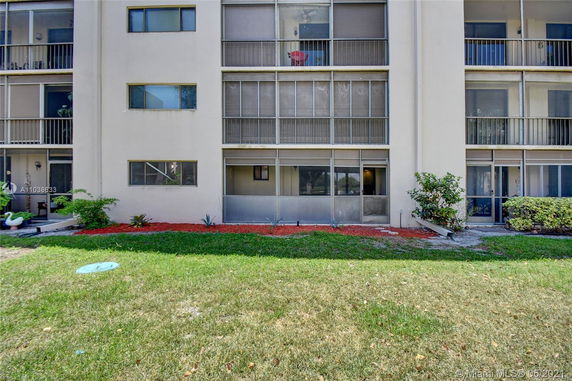 Front view of a multi-story apartment building with screened balconies.