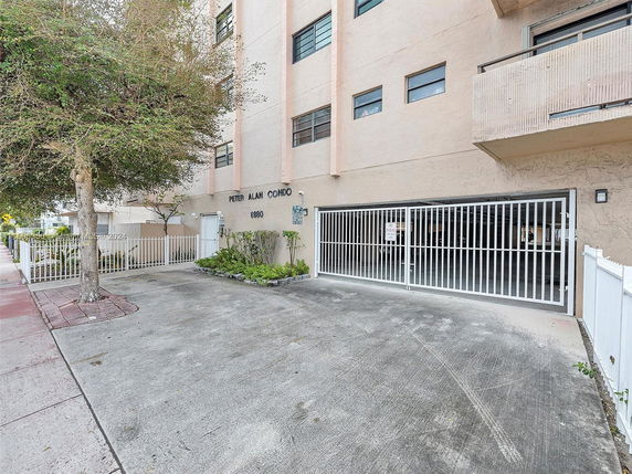 Outdoor parking area with gated entrance at a condominium building