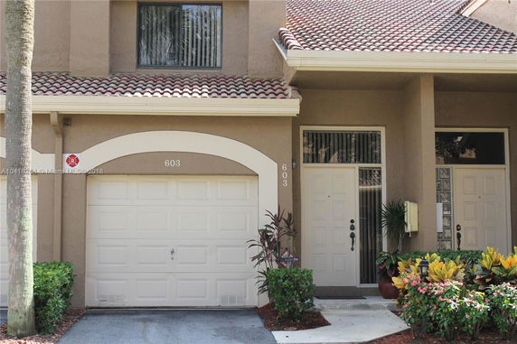 Front view of a house with a garage and entrance door.