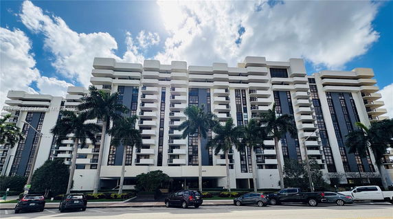 Front view of a multi-story apartment building with unique architectural design.