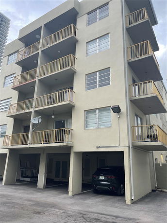 Front view of a multi-story building with balconies.