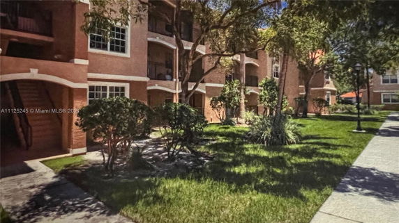 Front view of a multi-story residential building with balconies.