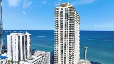 Front view of a high-rise building near the ocean.