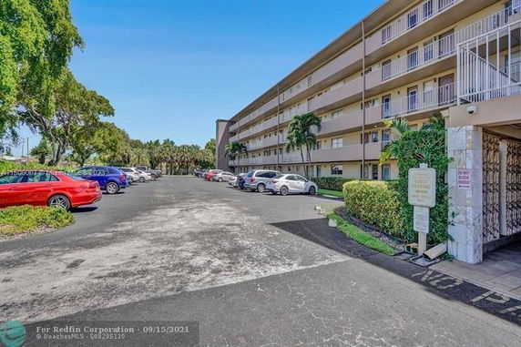 Outdoor parking area in front of a multi-story building