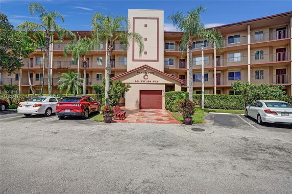 Front view of a multi-story residential building with balconies.
