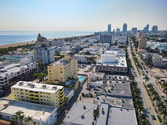 Panoramic view of a coastal cityscape with buildings and ocean in the background.