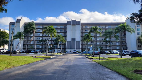Front view of a multi-story apartment building with balconies.