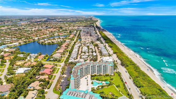 Panoramic view of coastal area with buildings, roads, and ocean.