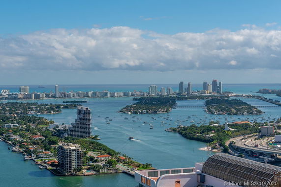 Panoramic view of a coastal cityscape with numerous buildings and waterways.