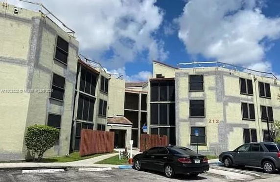 Front view of a three-story apartment building with multiple entrances.