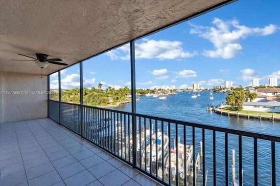 View from a balcony overlooking a waterway with buildings in the distance.