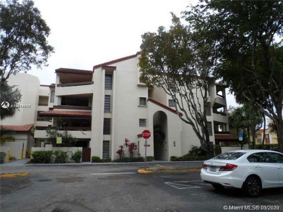Front view of a multi-story residential building with balconies.