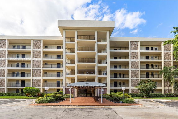 Front view of a mid-rise apartment building with multiple balconies.