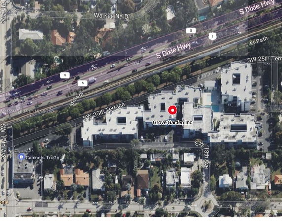 Aerial view of a building complex near a highway.