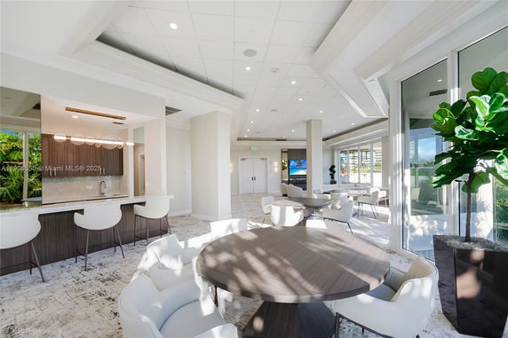 Interior view of a clubhouse with modern seating and a small bar area.