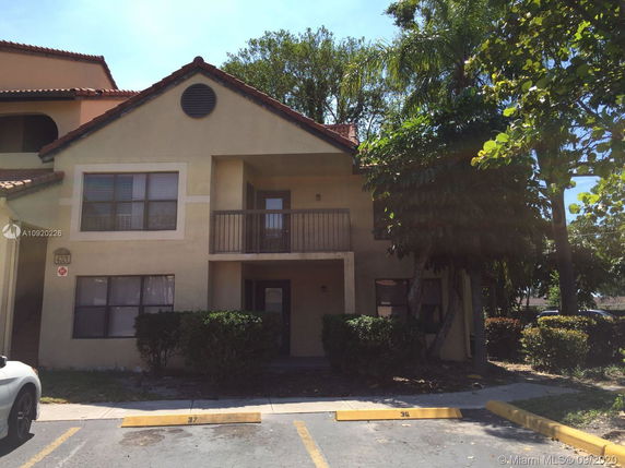 Front view of a two-story building with a small balcony.
