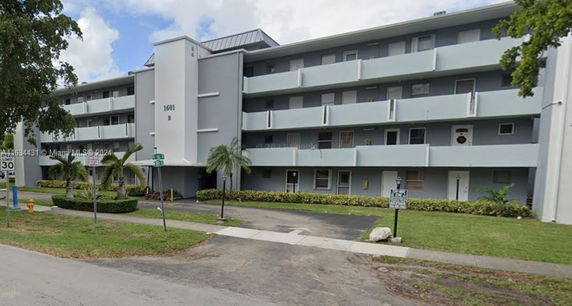 Front view of a multi-story residential building with balconies.