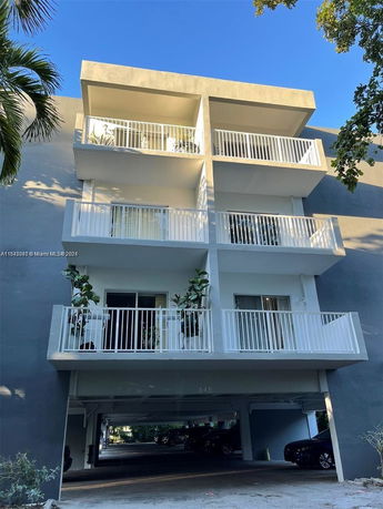 Front view of a multi-story building with balconies.