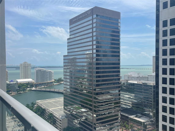 High-rise buildings with a view of a bay and distant bridge