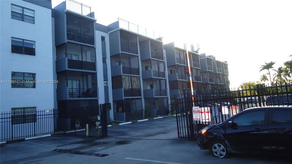 Front view of a multi-story residential apartment building with balconies.