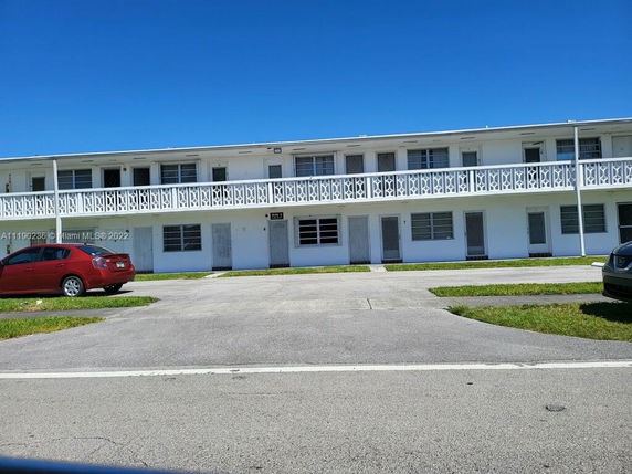 Front view of a two-story residential building with a balcony.