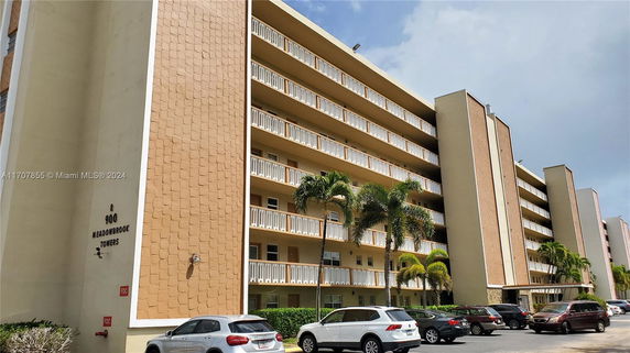 Front view of a multi-story residential building with balconies.
