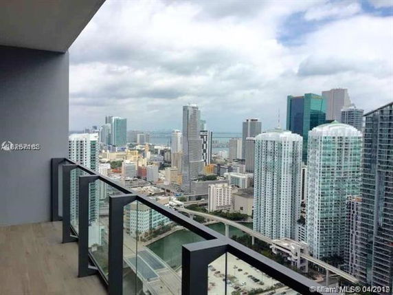 Panoramic view from a high-rise building overlooking a city skyline with various skyscrapers.