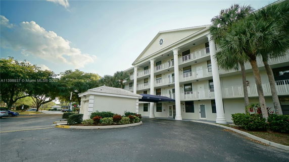 Front view of a multi-story building with large columns and balconies.