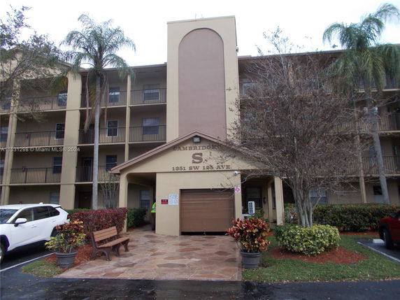 Front view of a multi-story residential building with balconies.