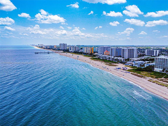Panoramic view of a coastline with numerous beachfront high-rise buildings.