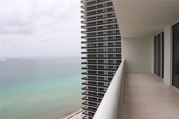 Balcony view overlooking the ocean from a high-rise building.