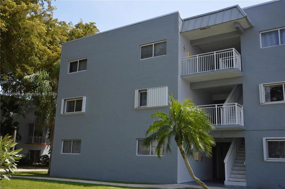 Front view of a multi-story residential building with balconies.