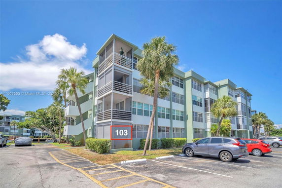 Front view of a multi-story apartment building with balconies.