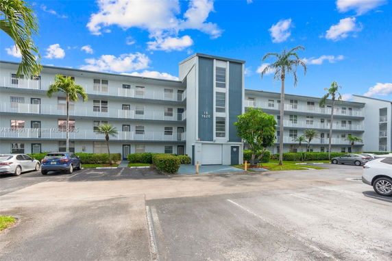 Front view of a multi-story residential building with balconies.