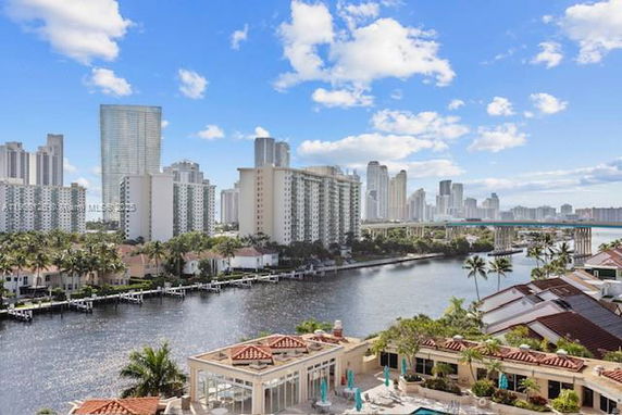 Panoramic view of a waterfront area with tall buildings in the background.