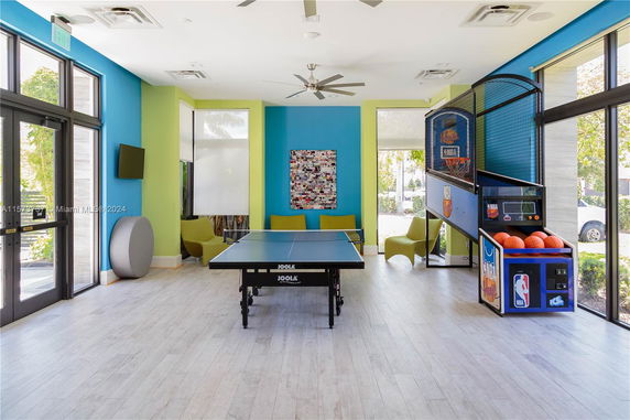 Indoor recreation area with table tennis and basketball arcade game.