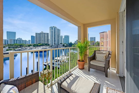 Balcony view of high-rise buildings and waterfront.
