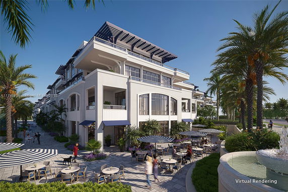 Front view of a modern multi-story residential building with balconies and outdoor seating.
