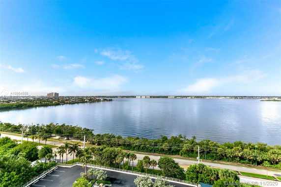 Wide angle view of a body of water with a distant shoreline and clear sky.