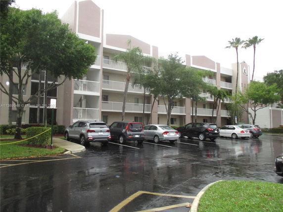 Front view of a multi-story residential building with balconies.