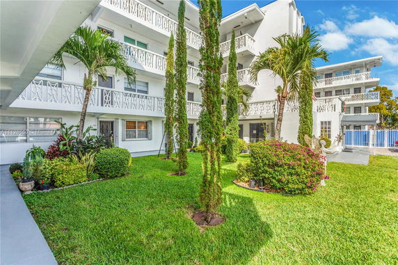 Front view of a multi-story apartment building with balconies.
