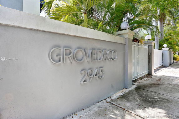 Front view of a building's entrance sign with the name 'GROVE DECO' and the number '2945'.